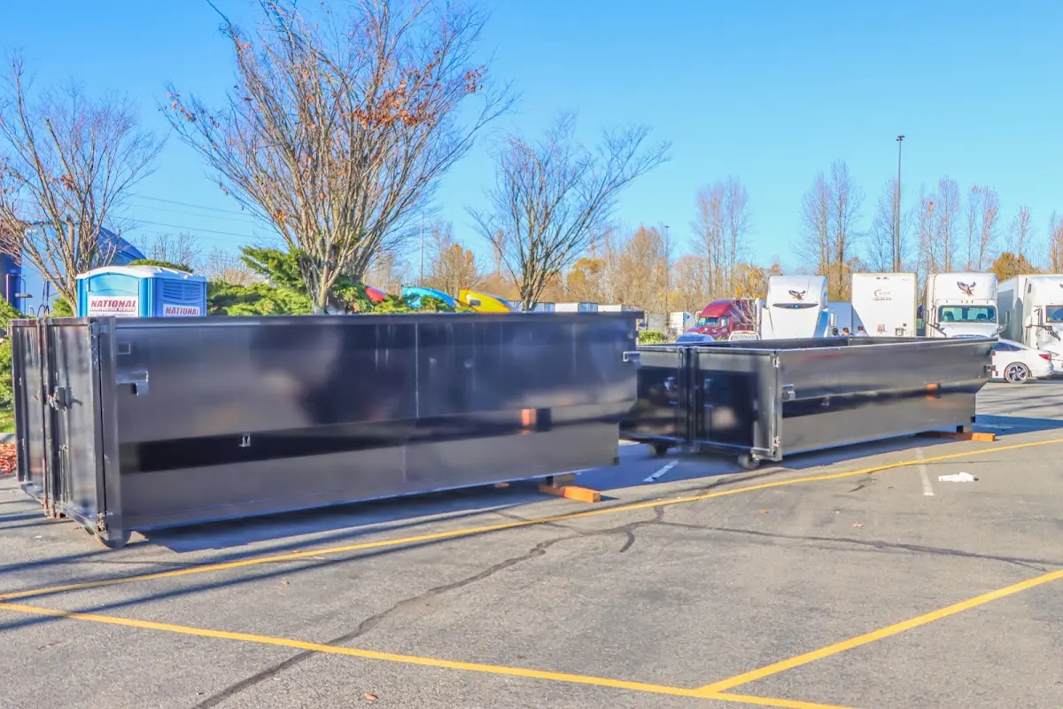 Professional dumpster rental service with roll-off container on residential driveway in Nitro